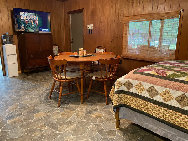 Dining table, bed, and indoor Roku TV